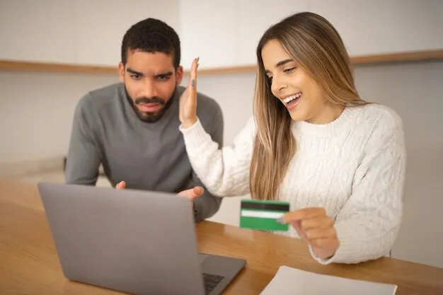 Couple reviewing energy bills on laptop